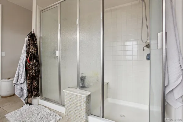 a bathroom with a shower and a sink