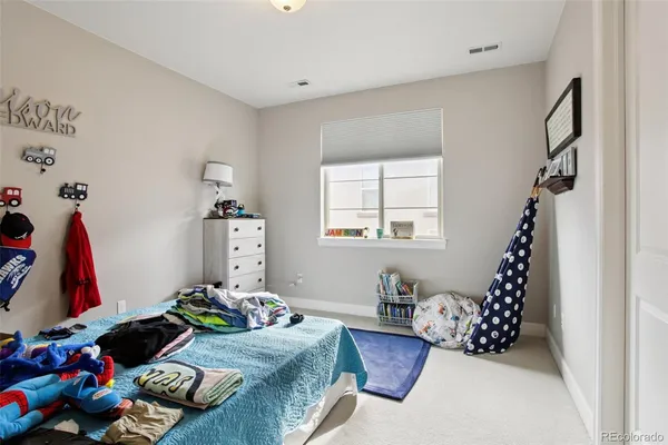 a bedroom with bed and a window