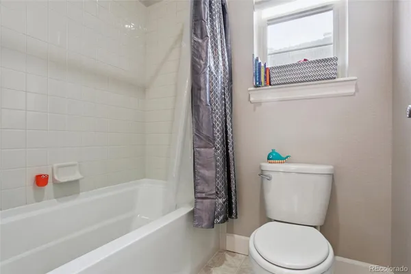 a white toilet sitting next to a bath tub