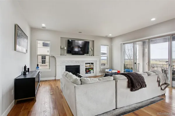 a living room with fireplace furniture and a flat screen tv