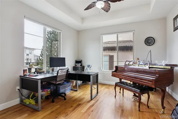 a view of a workspace with furniture and a window