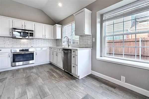 a kitchen with stainless steel appliances granite countertop a stove and a sink