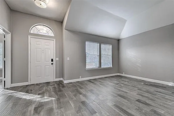 an empty room with windows mirror and window