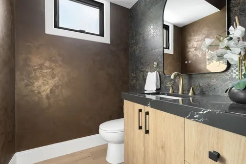 a bathroom with a toilet sink and mirror