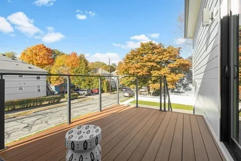 a view of a balcony with wooden floor