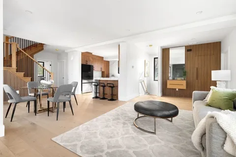 a living room with furniture a dining table and a flat screen tv