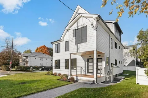 a view of a white building among the yard