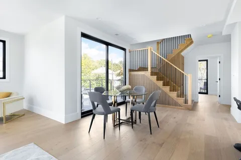 a dining room with furniture window and wooden floor