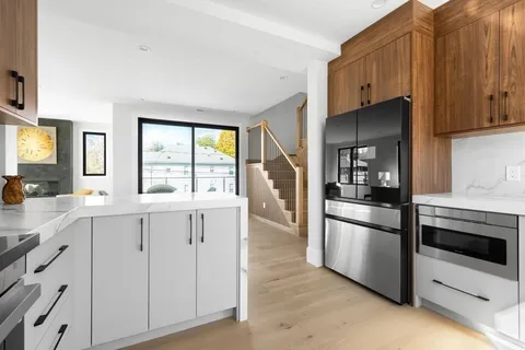a kitchen with white cabinets and appliances