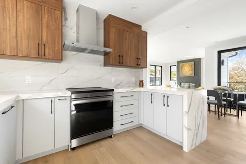 a kitchen with white cabinets and white appliances