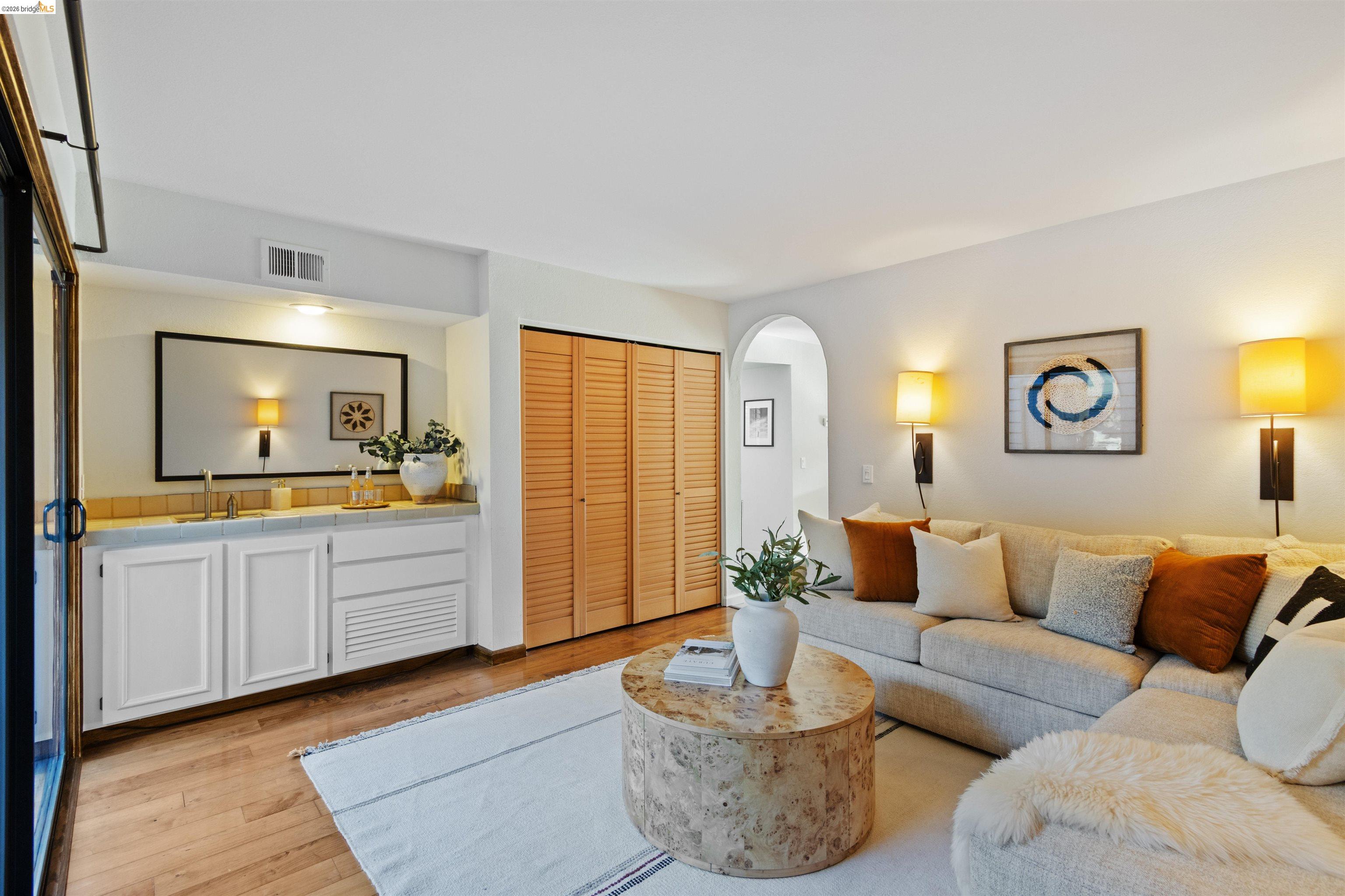 548 Queen's Road Alameda, CA 94501 - Photo 19 of 42 Living room featuring light wood finished floors and arched walkways