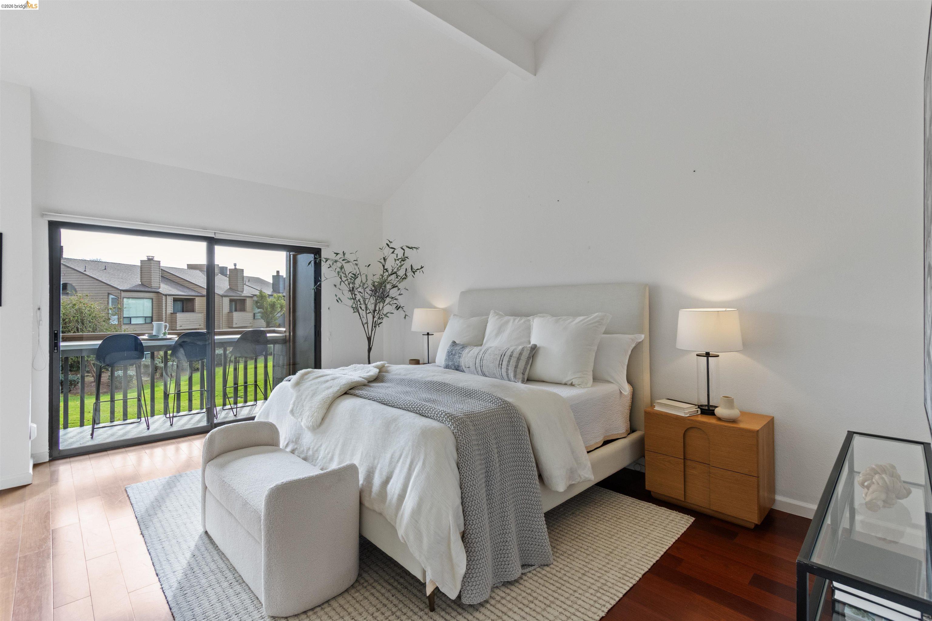 548 Queen's Road Alameda, CA 94501 - Photo 27 of 42 Bedroom featuring access to exterior, lofted ceiling, and wood finished floors