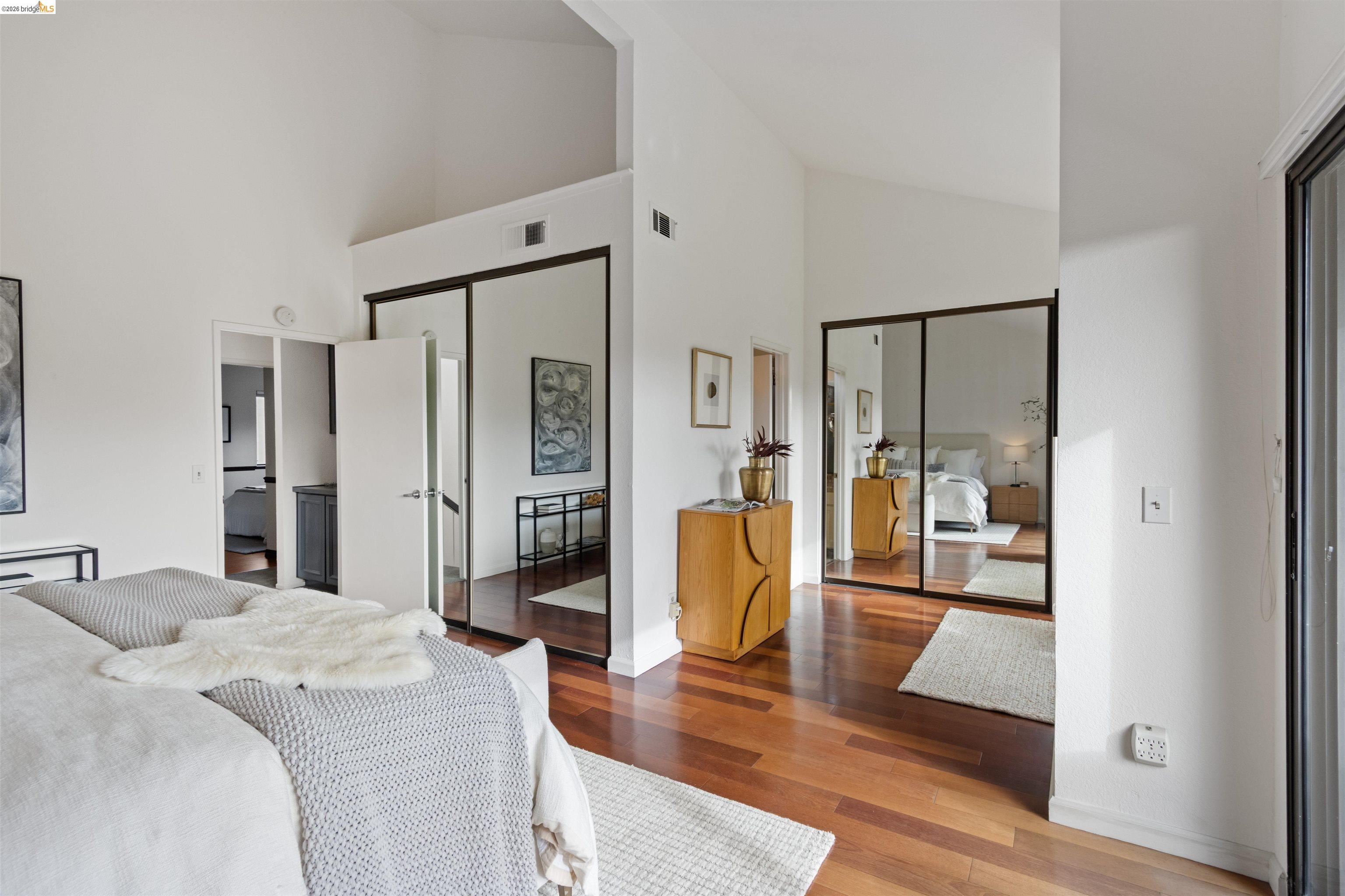 548 Queen's Road Alameda, CA 94501 - Photo 28 of 42 Bedroom with multiple closets, wood finished floors, ensuite bath, and lofted ceiling