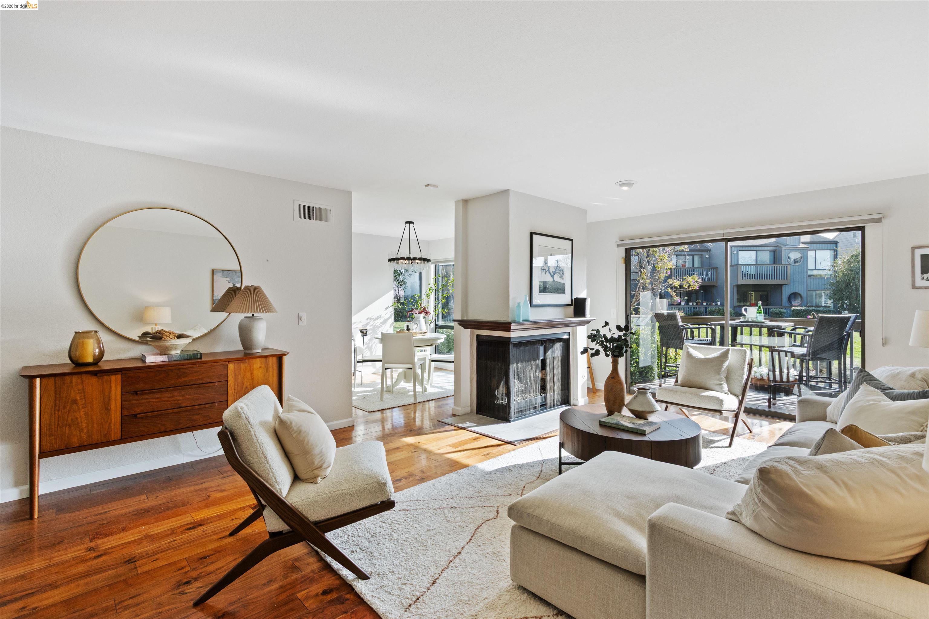 548 Queen's Road Alameda, CA 94501 - Photo 3 of 42 Living room featuring hardwood / wood-style floors and a multi sided fireplace
