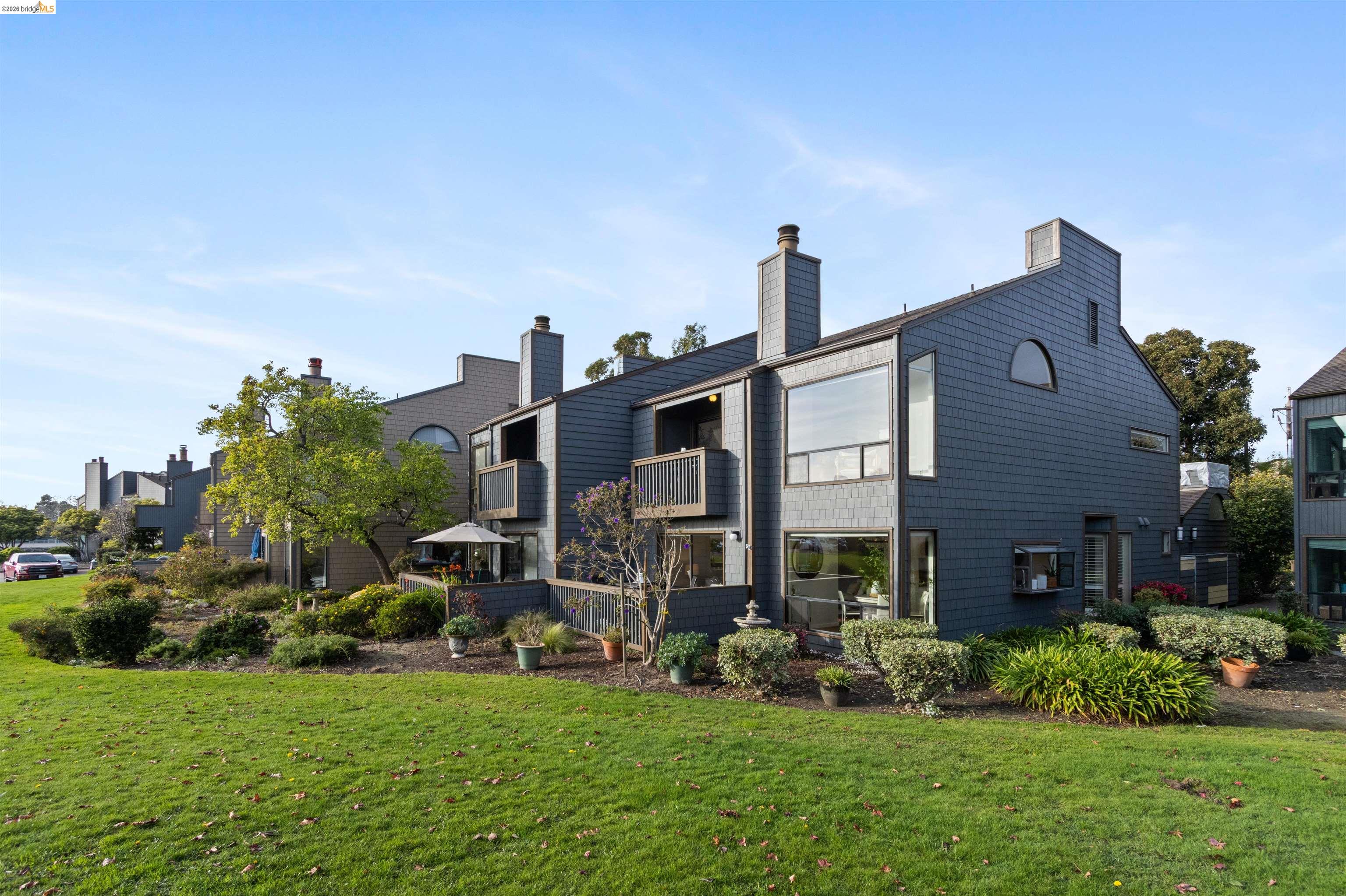 548 Queen's Road Alameda, CA 94501 - Photo 35 of 42 Rear view of property featuring a balcony, a yard, and a chimney