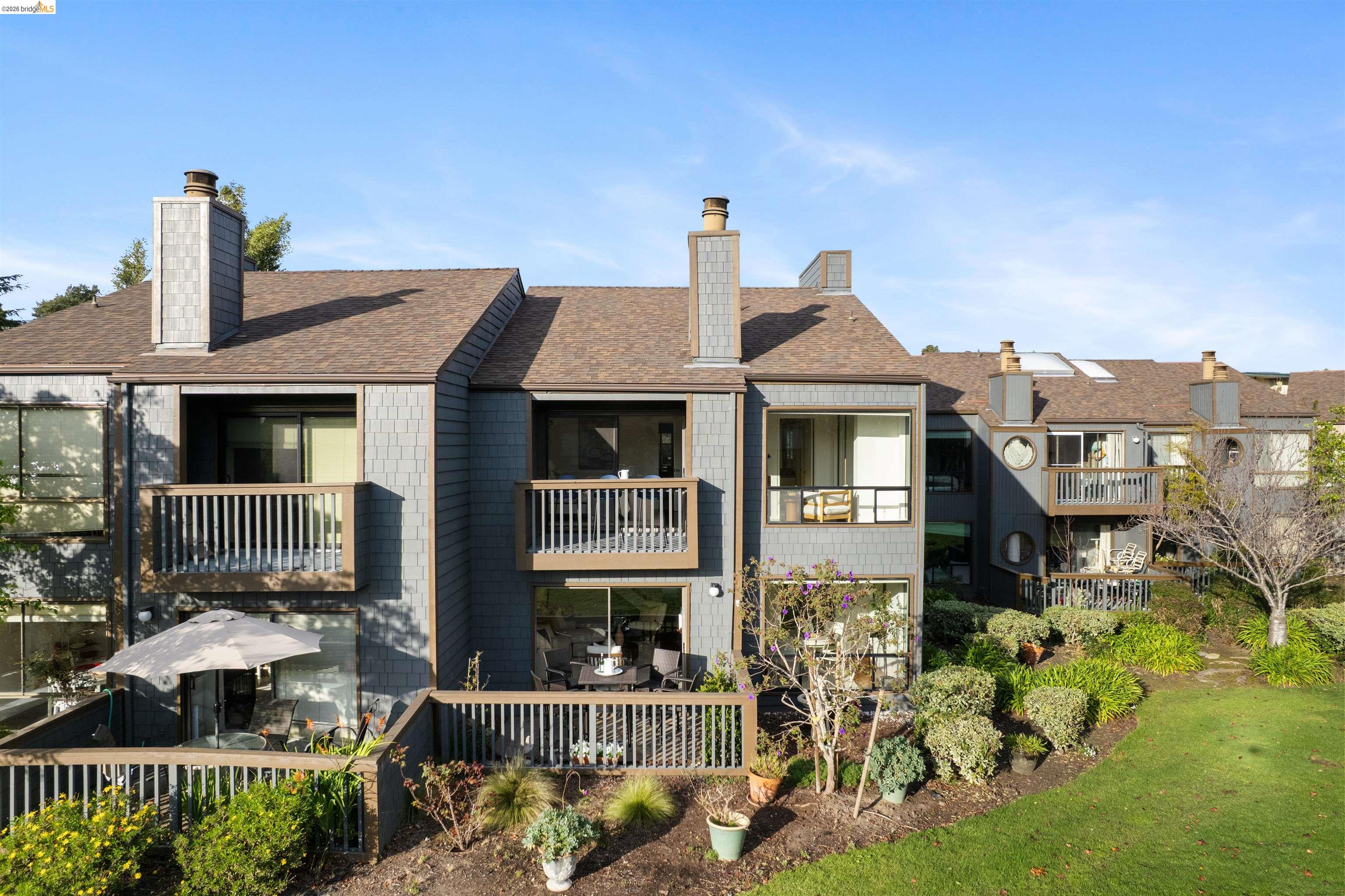 548 Queen's Road Alameda, CA 94501 - Photo 36 of 42 Rear view of property featuring a chimney, a shingled roof, and a balcony