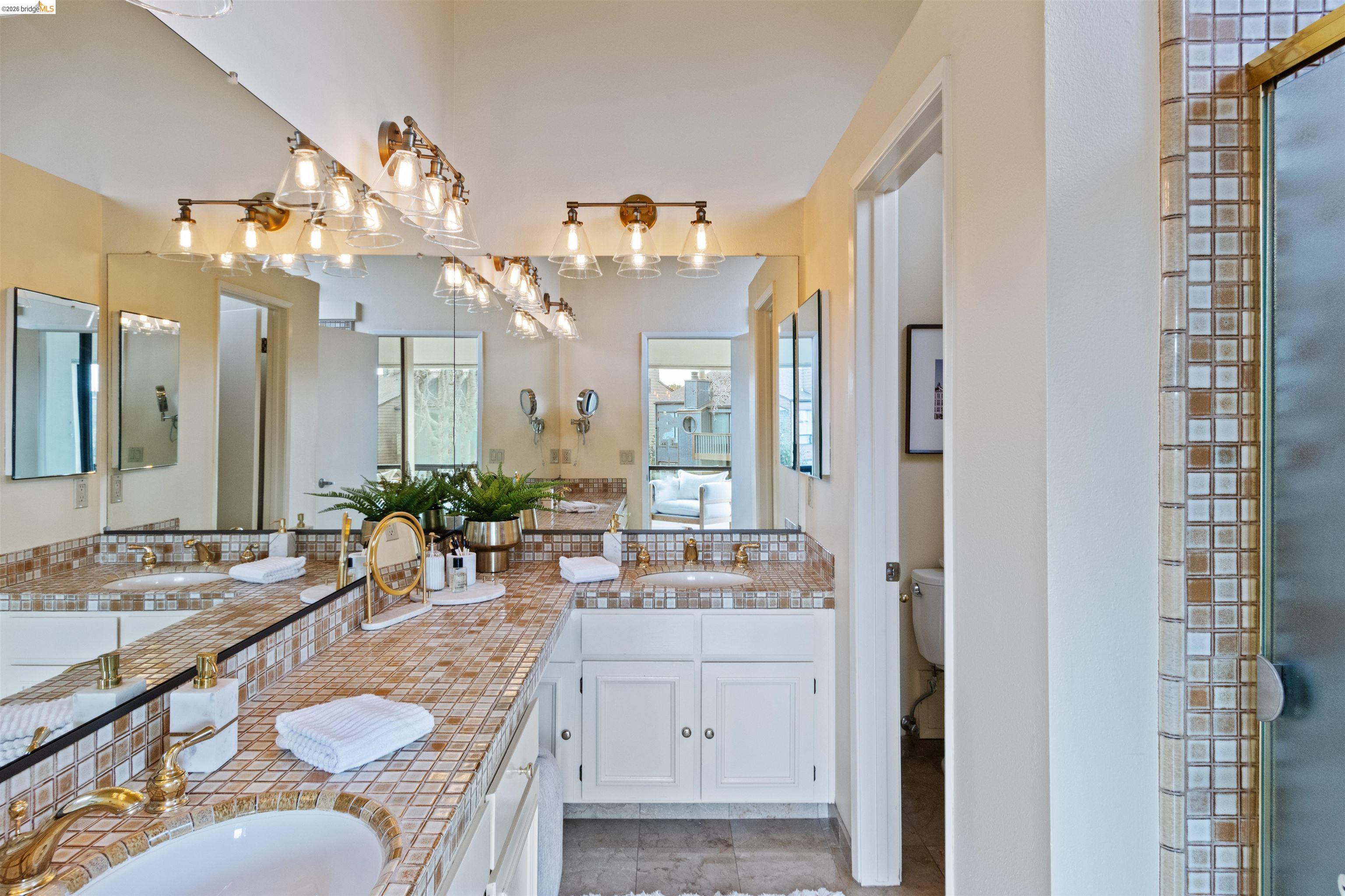 548 Queen's Road Alameda, CA 94501 - Photo 40 of 42 Full bath featuring connected bathroom, double vanity, and a shower with shower door