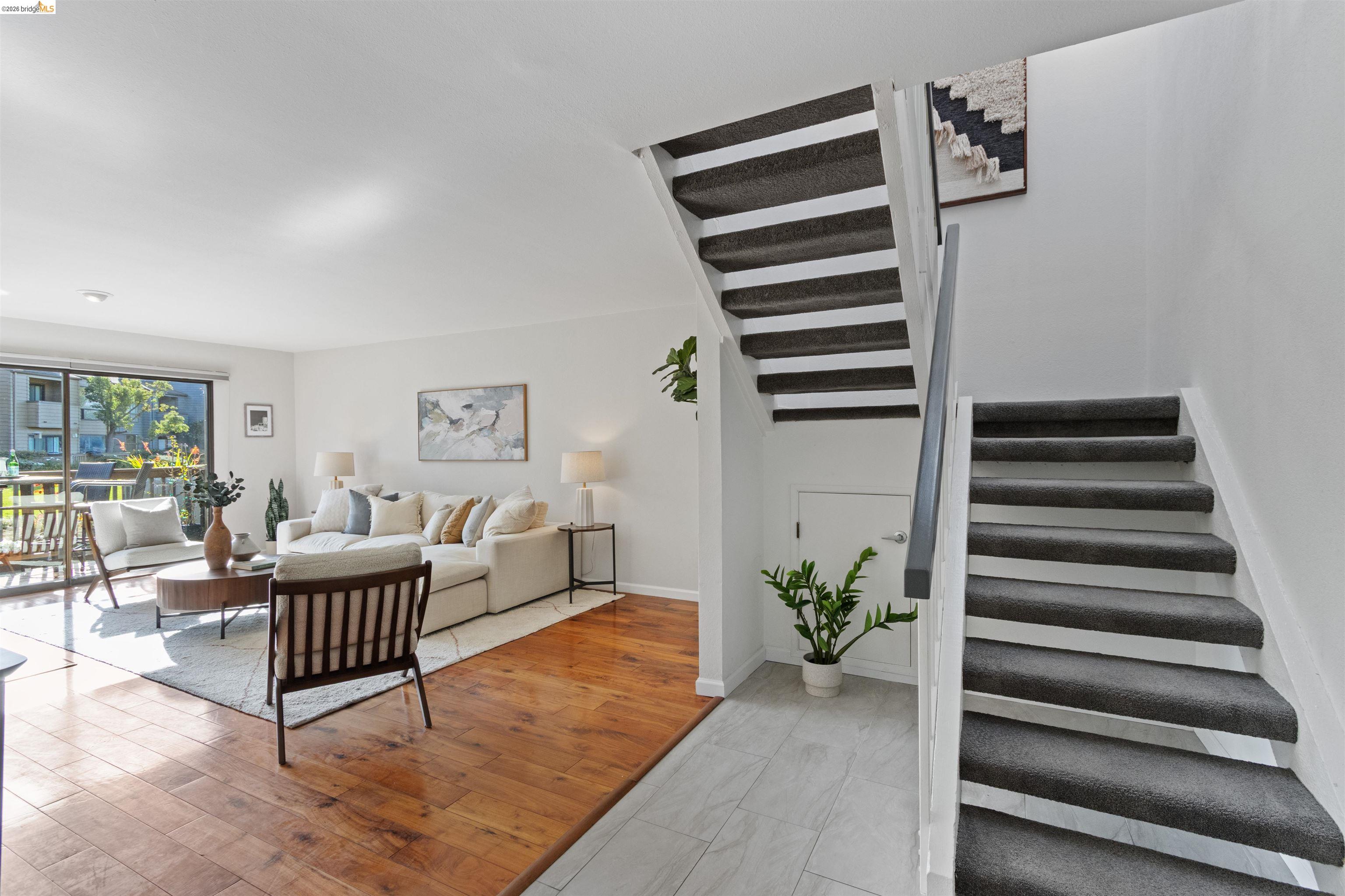 548 Queen's Road Alameda, CA 94501 - Photo 4 of 42 Living area featuring stairway and light wood-style floors