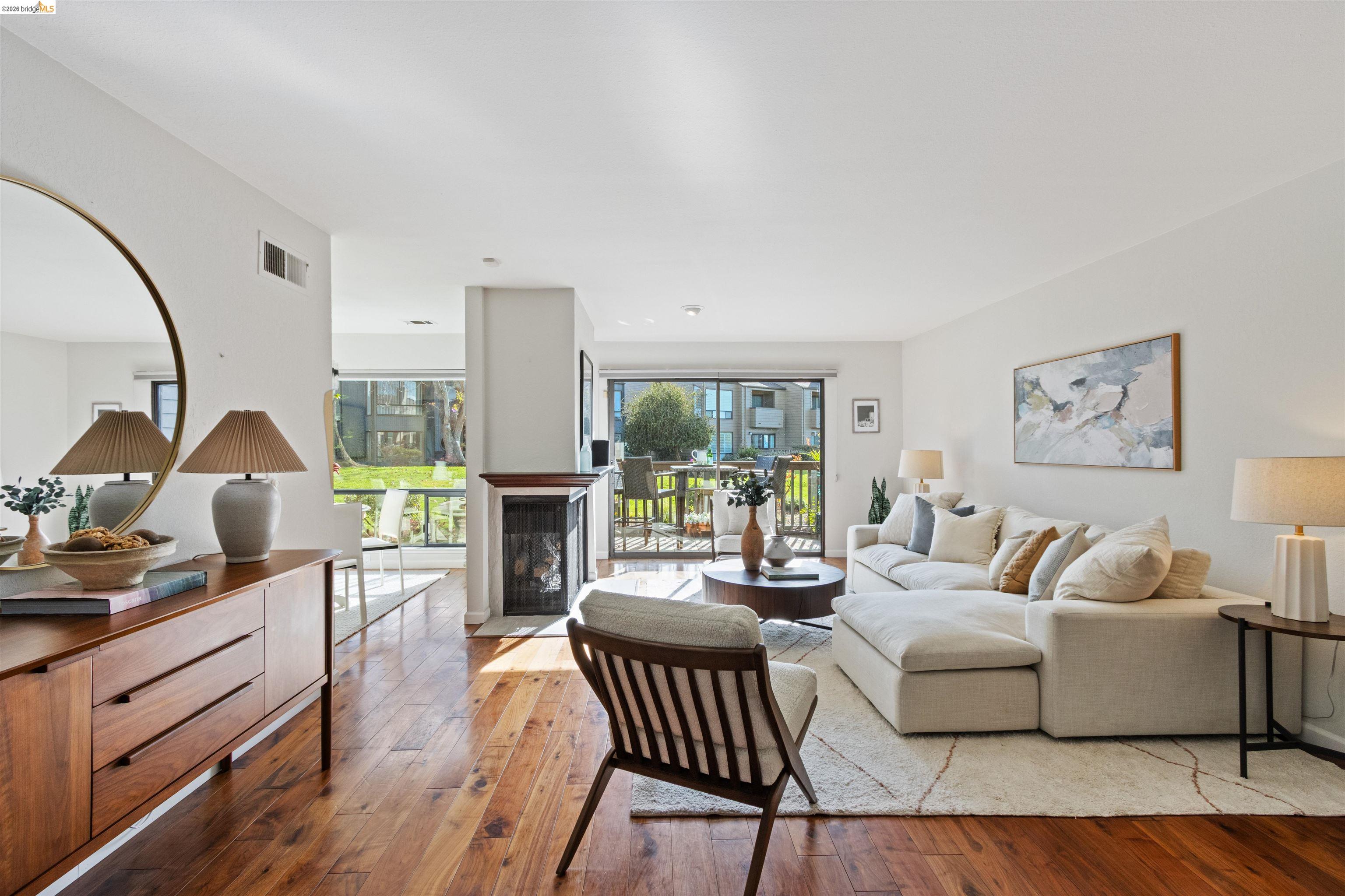 548 Queen's Road Alameda, CA 94501 - Photo 5 of 42 Living room with wood-type flooring and a fireplace with flush hearth