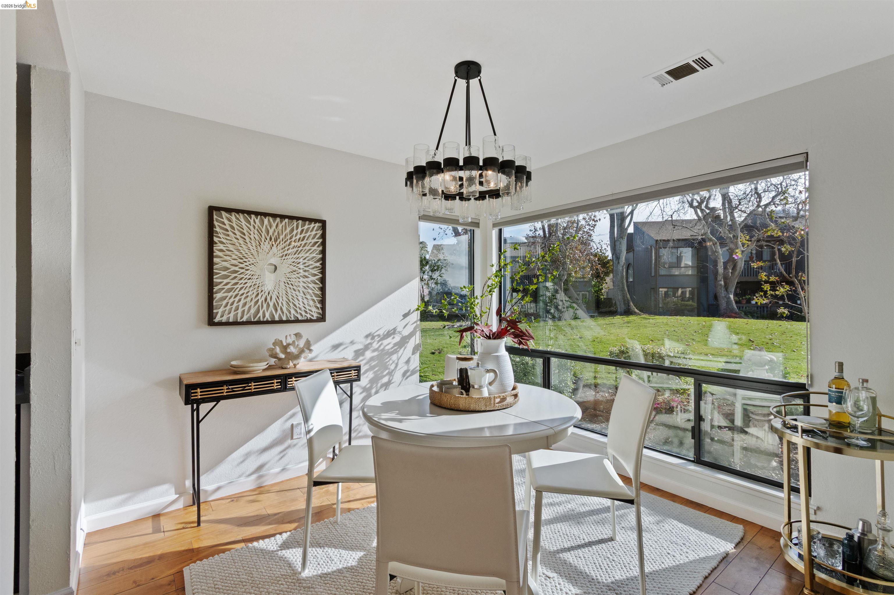 548 Queen's Road Alameda, CA 94501 - Photo 7 of 42 Dining area featuring hardwood / wood-style flooring and suspended lighting