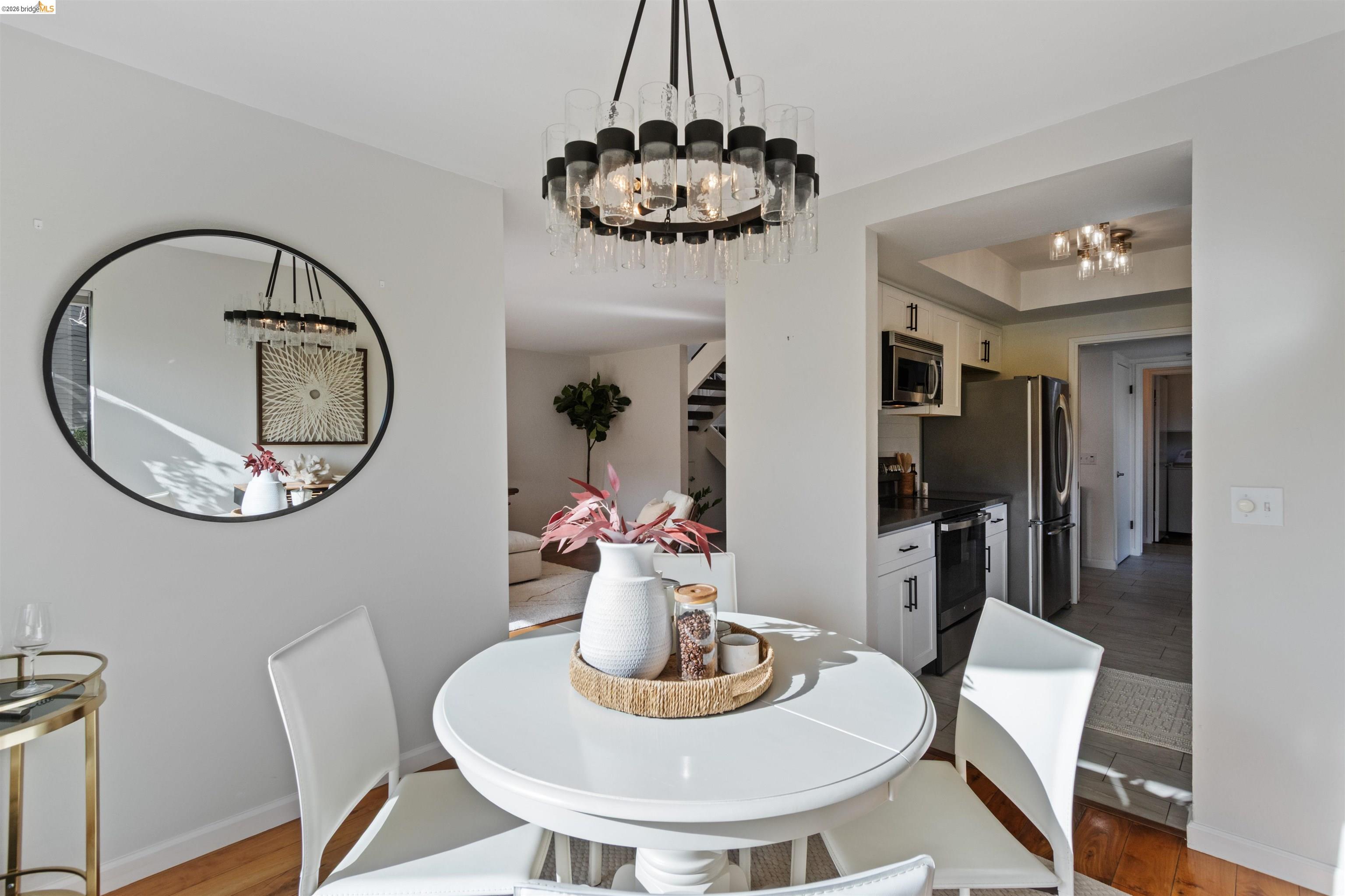 548 Queen's Road Alameda, CA 94501 - Photo 8 of 42 Dining area featuring light wood-type flooring, a chandelier, and a raised ceiling