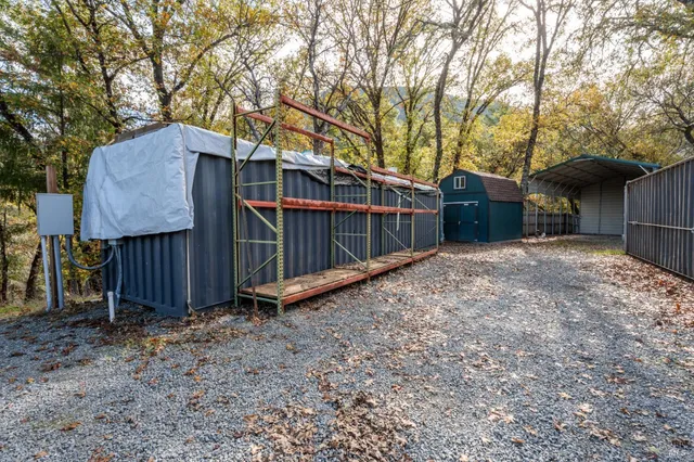 a view of a backyard with a small cabin and a chair