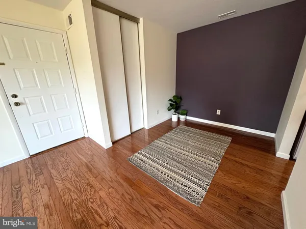 a view of a room with wooden floor