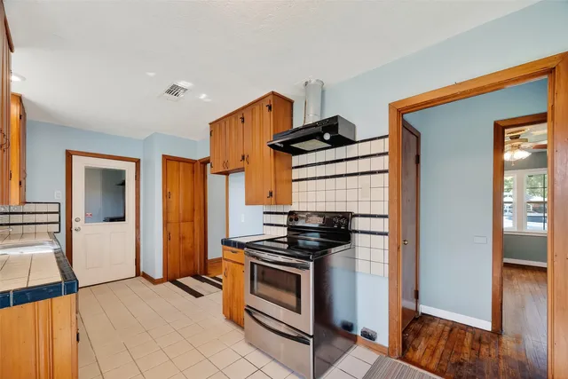 a kitchen with stainless steel appliances a stove and a refrigerator