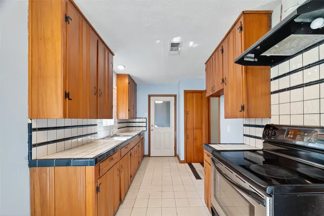 a kitchen that has a sink and a stove