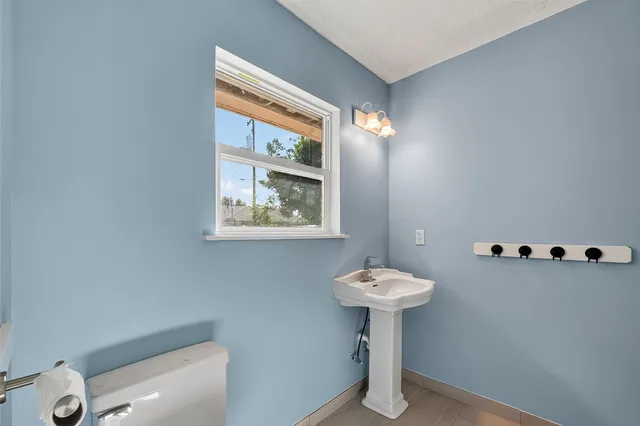 a bathroom with a sink toilet and a mirror