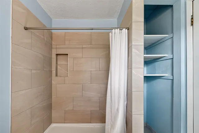 a bathroom with a glass shower door