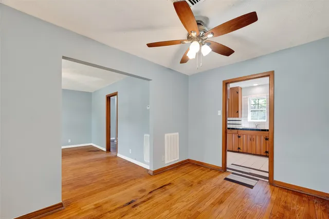 a view of an empty room with wooden floor