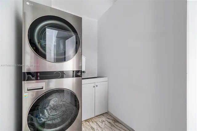 a close view of a utility room with dryer and washer