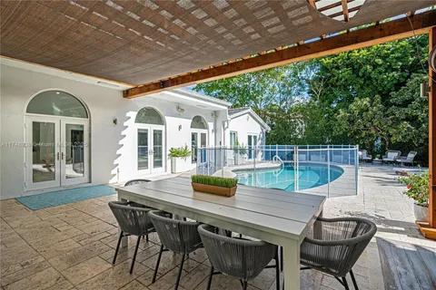 a view of a patio with table and chairs and wooden floor
