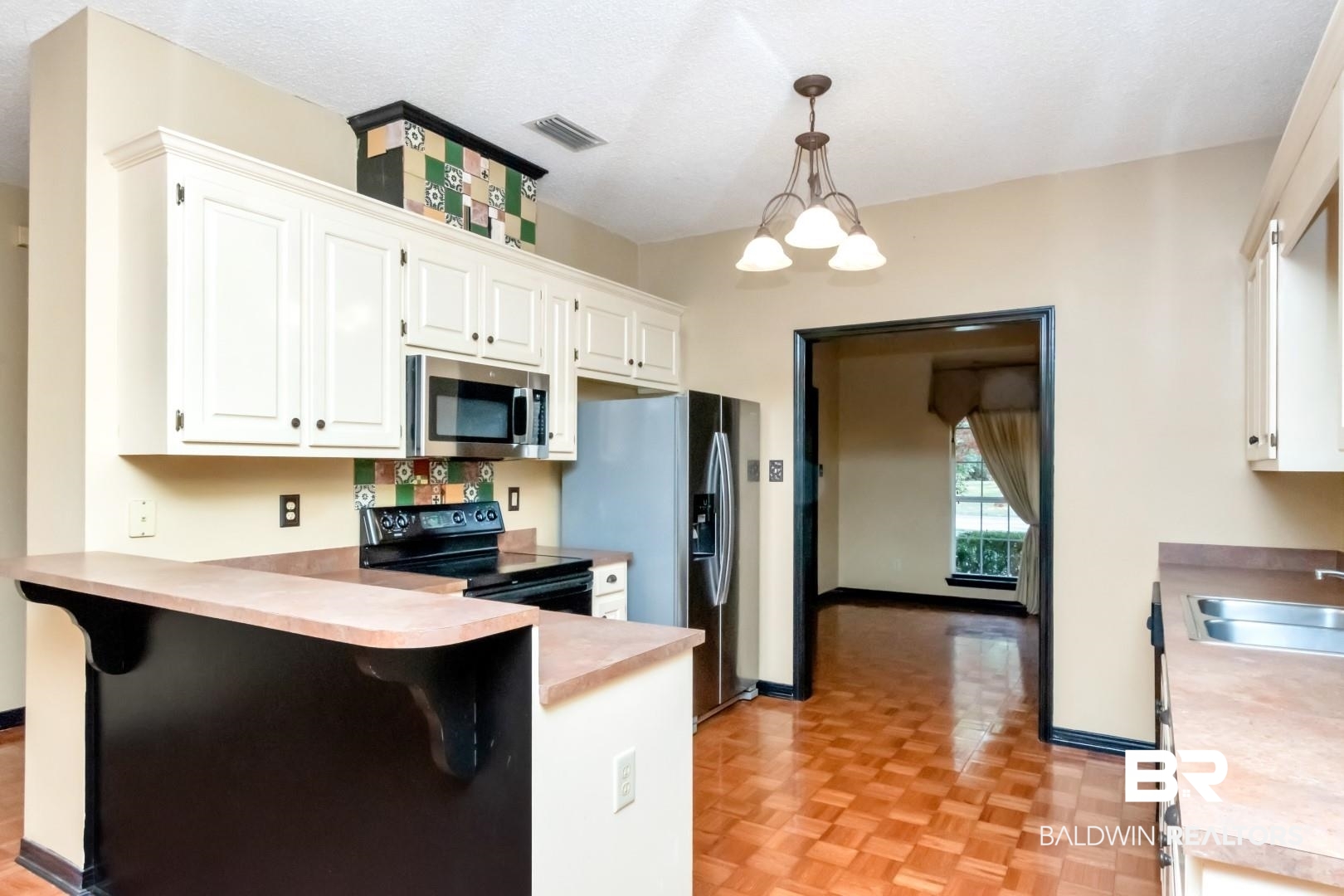 152 Ideal Avenue Mobile, AL 36608 - Photo 15 of 32 Kitchen with sink, kitchen peninsula, pendant lighting, a breakfast bar area, and appliances with stainless steel finishes
