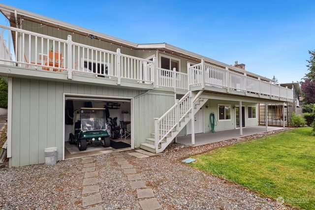 a view of a house with backyard porch and sitting area