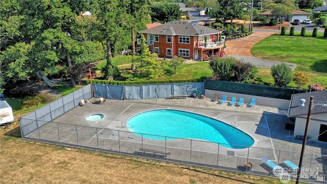 a roof deck with table and chairs and wooden fence