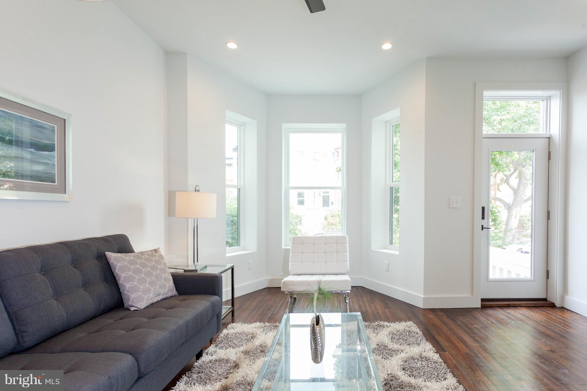 15 R Street Northeast, Unit A Washington, DC 20002 - Photo 2 of 25 a living room with furniture and a large window