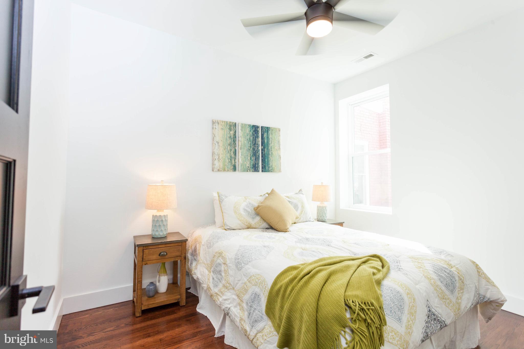 15 R Street Northeast, Unit A Washington, DC 20002 - Photo 15 of 25 a bedroom with a bed and a chandelier