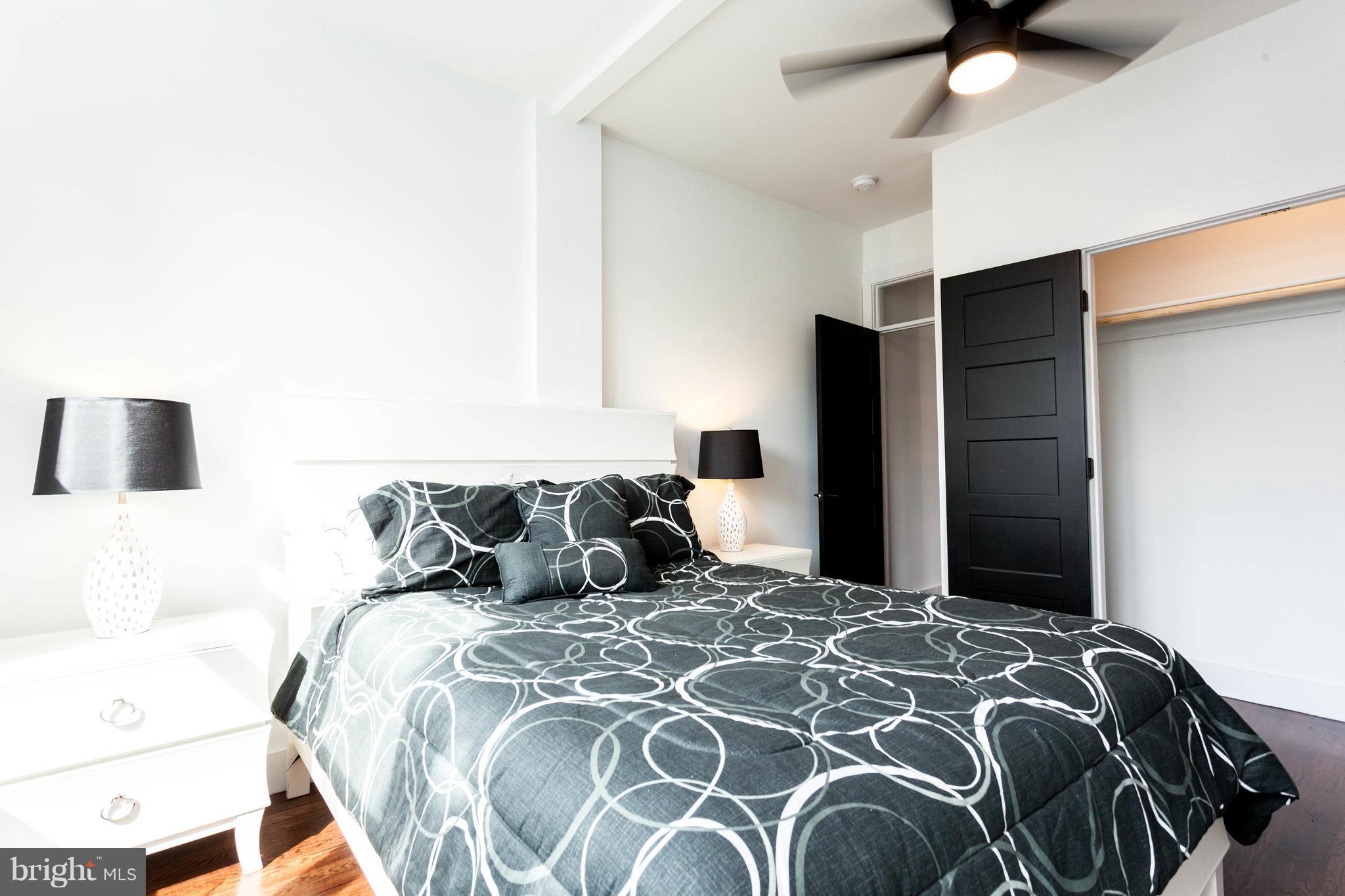 15 R Street Northeast, Unit A Washington, DC 20002 - Photo 16 of 25 a bedroom with a large bed and a chandelier