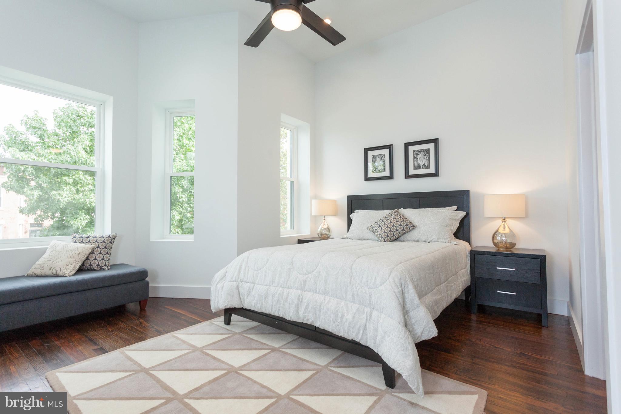 15 R Street Northeast, Unit A Washington, DC 20002 - Photo 19 of 25 a bedroom with a bed and a couch