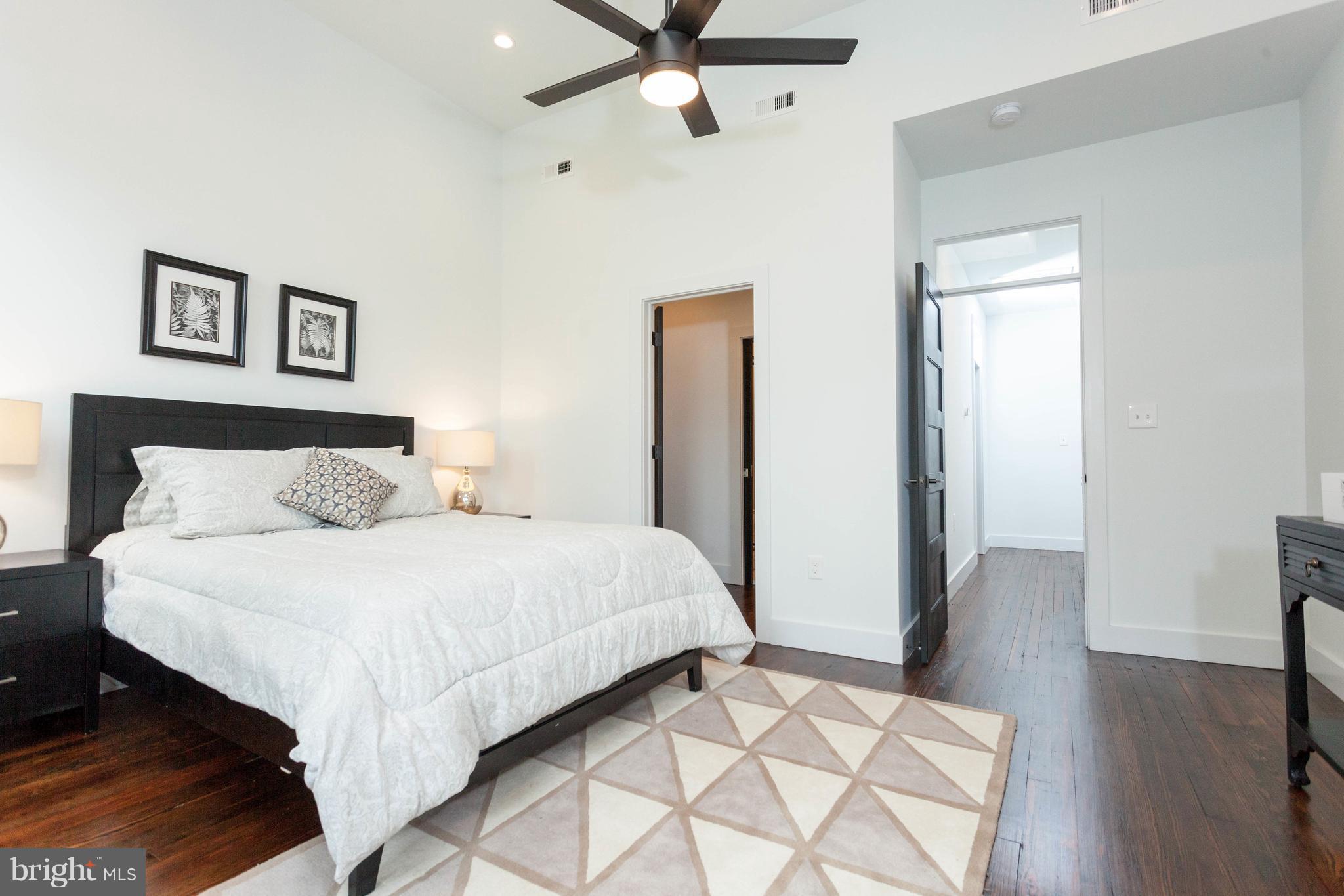 15 R Street Northeast, Unit A Washington, DC 20002 - Photo 20 of 25 a bedroom with a bed and wooden floor