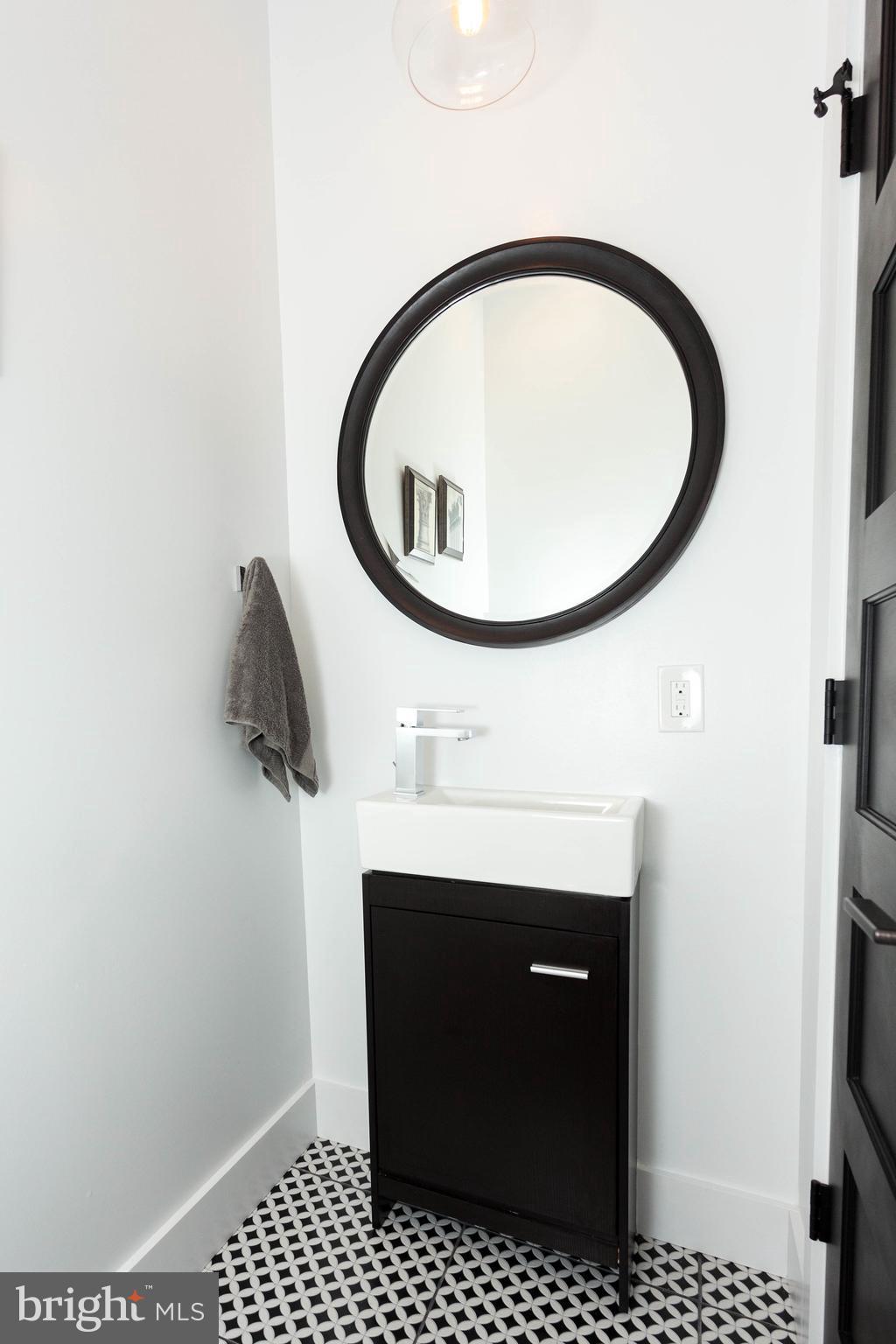 15 R Street Northeast, Unit A Washington, DC 20002 - Photo 3 of 25 a bathroom with a sink and a mirror