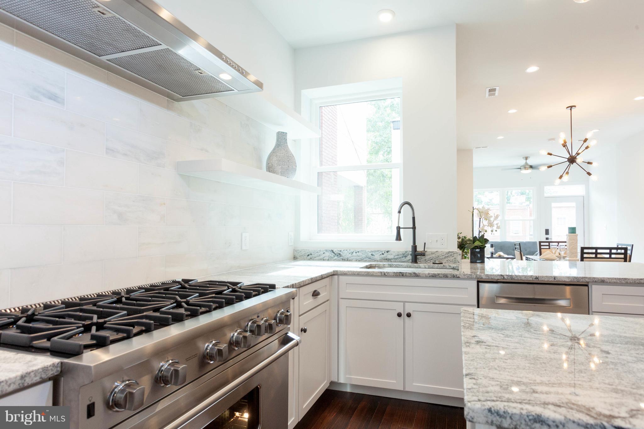 15 R Street Northeast, Unit A Washington, DC 20002 - Photo 6 of 25 a kitchen with granite countertop a sink stove and cabinets