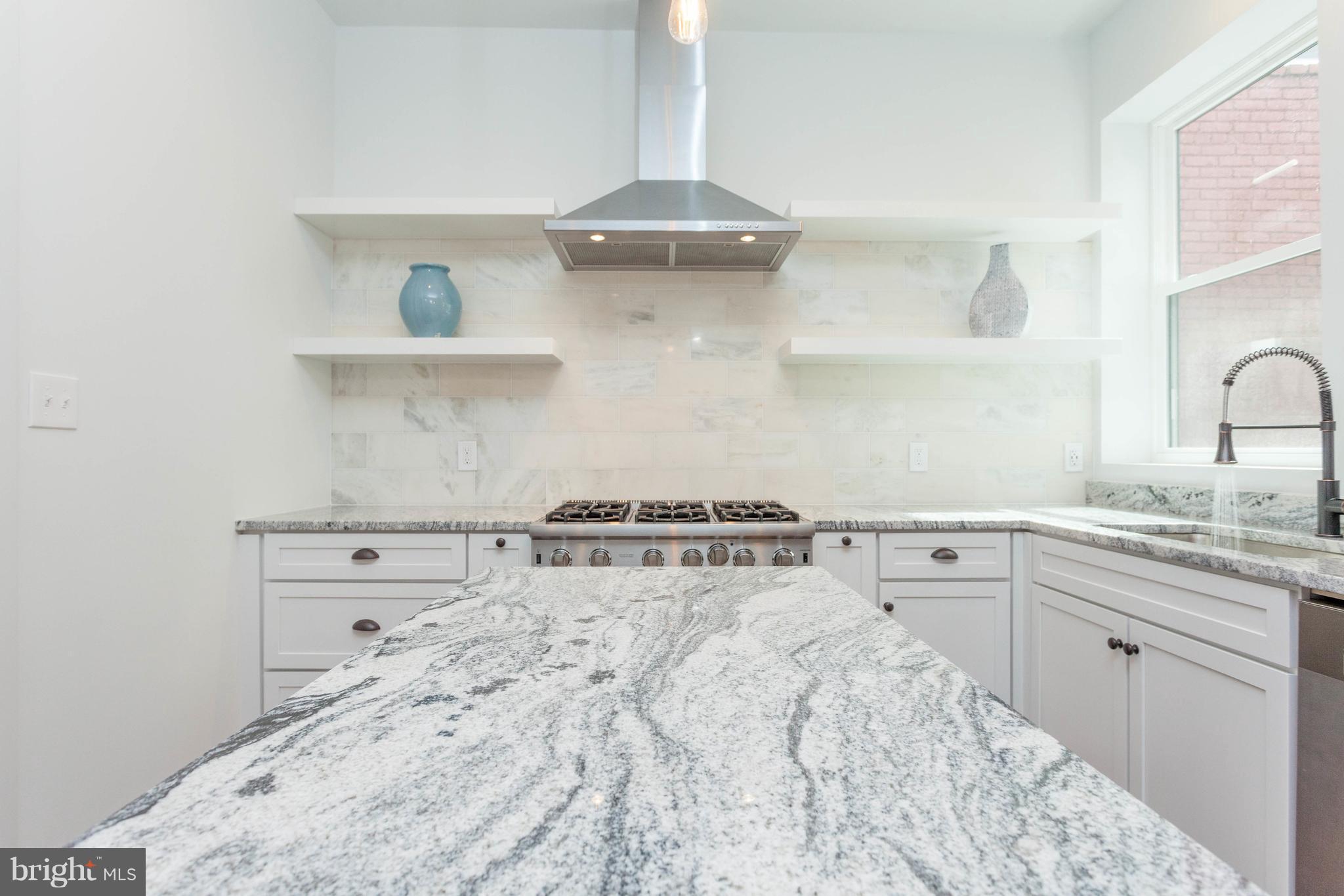 15 R Street Northeast, Unit A Washington, DC 20002 - Photo 7 of 25 a kitchen with a stove and cabinets