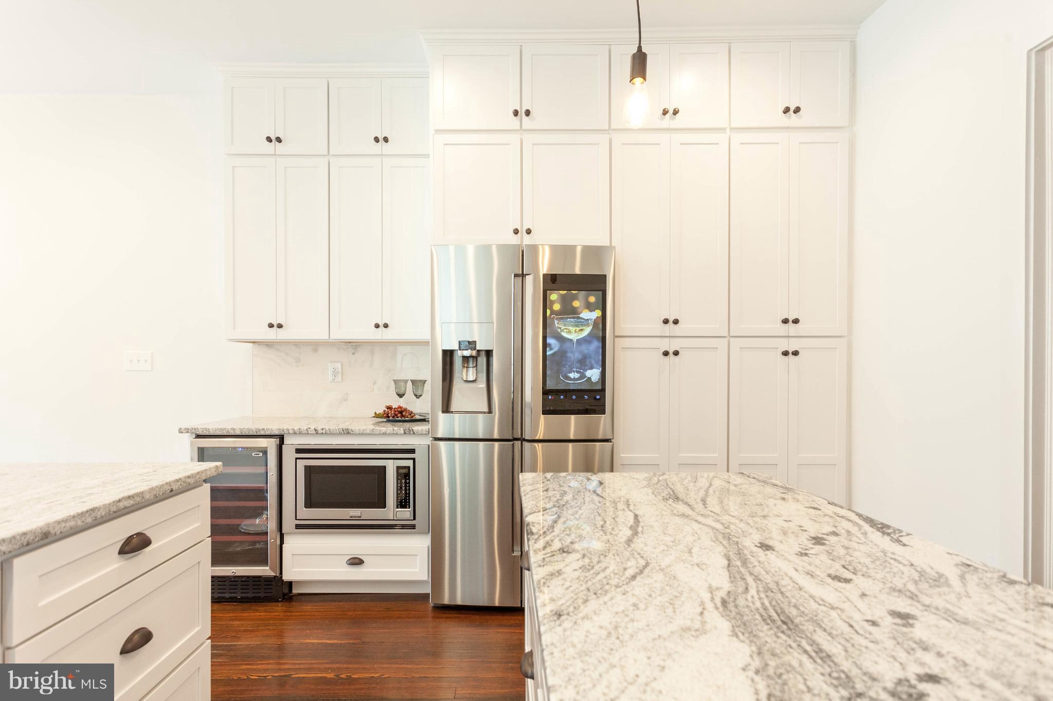 15 R Street Northeast, Unit A Washington, DC 20002 - Photo 8 of 25 a kitchen with stainless steel appliances a refrigerator and white cabinets