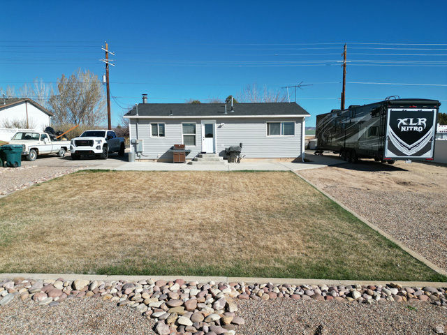 1852 East 3500th Street South Vernal, UT 84078 - Photo 39 of 46 Single story home featuring a back yard, a patio, and entry steps