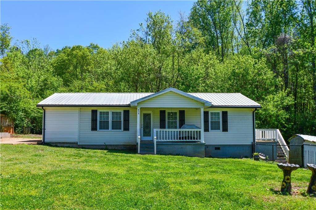 858 Old Airport Road Commerce, GA 30530 - Photo 1 of 1 a front view of a house with a garden