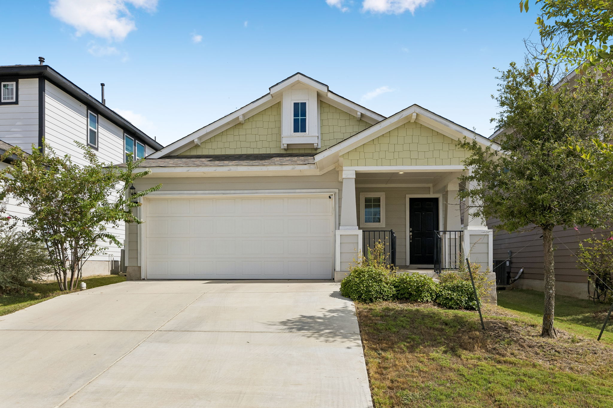 164 Appleberry Lane Elgin, TX 78621 - Photo 1 of 40 A concrete driveway leads to a welcoming front porch and attached two-car garage.