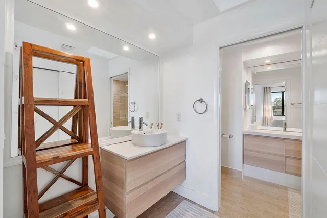 a bathroom with a sink a vanity and a mirror